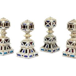 FOUR MOTHER-OF-PEARL AND COLOURED GLASS CHARPAI LEGS
India, 19th century. Of typical shape, each leg resting on a squared flat base rising to a stepped pyramidal and squared structure, with a ringed neck and polygonal hollow head, the exterior completely clad in mother-of-pearl tesserae held in place with now oxidised copper pins, the base and head of each leg filled with foil-backed red and blue-coloured glass sheets, cut in geometric patterns. Size 37.5 cm FOUR MOTHER-OF-PEARL AND COLOURED GLASS CHARPAI LEGS