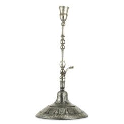The huqqa of typical bell-like shape, resting on a larger circular base, surmounted by a tapering bulbous silver staff with a dragon-headed spout and hourglass-shaped brazier, at the top a scalloped silver brazier cup with pierced and engraved floral pattern and a fretwork band below the rim, the bidri silver-inlaid decoration on the huqqa and its base consisting of oval medallions of intricate and lush floral sprays flanked by baluster-like columns supporting squinches with thick foliage and further vegetal motifs, around the borders concentric bands of vines and flower head roundels,