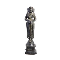 standing on a raised plinth, holding a yoni-shaped lamp bowl, her hair gathered in a pony-tail, devanagari inscriptions on the reverse